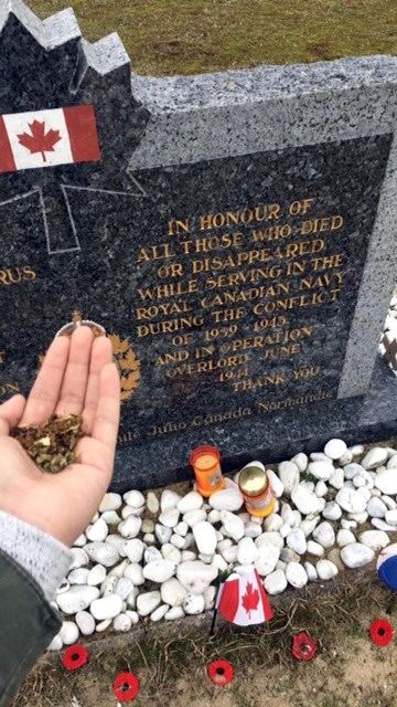 Sariane Fiddler makes an offering of tobacco at a warm memorial near Juno Beach to honor her family members and all indigenous peoples who served in the First and Second World Wars. 