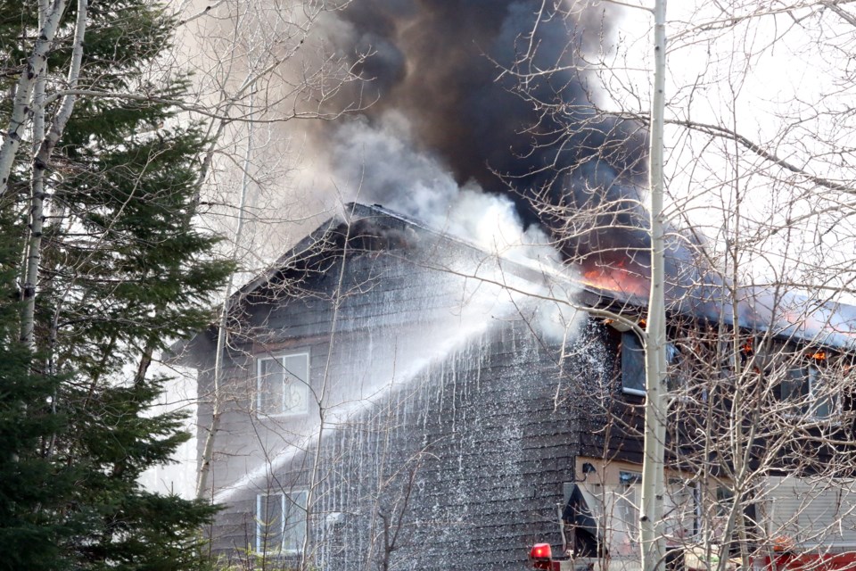Crews with Thunder Bay Fire Rescue battle a fire on a three-story home on Government Road Wednesday afternoon. 