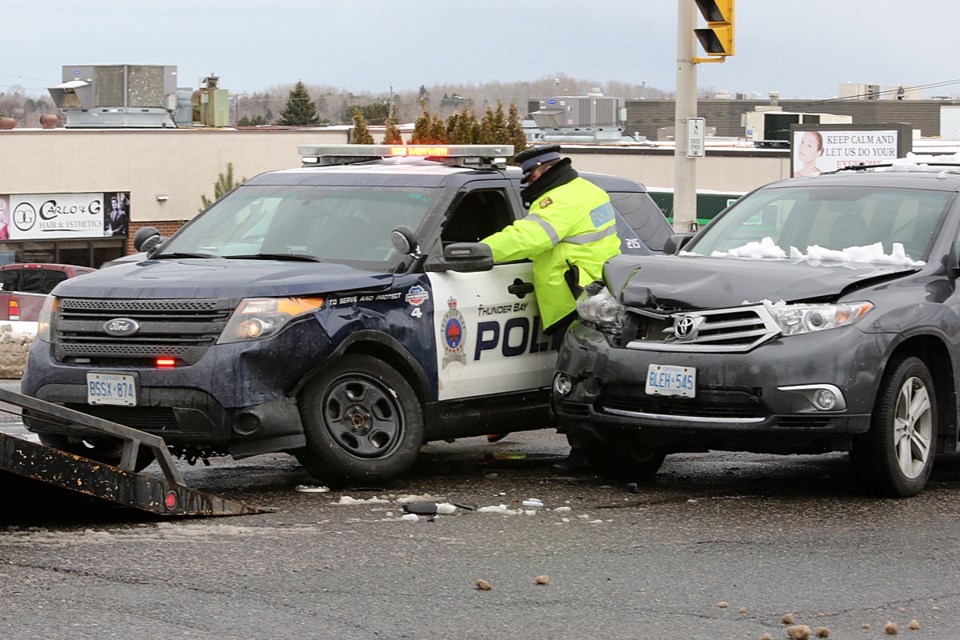 Police help tow-truck operators remove a Thunder Bay Police Service cruiser from the intersection of Dawson Road and East Avenue on Friday, April 28, 2017 (Leith Dunick, tbnewswatch.com). 
