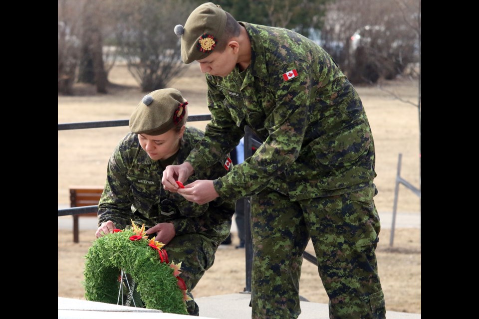 Members of the Lake Superior Scottish Regiment add poppies to a wreath at the Cenotaph in Waverly Park to mark the 100th anniversary of the Battle of Vimy Ridge. 