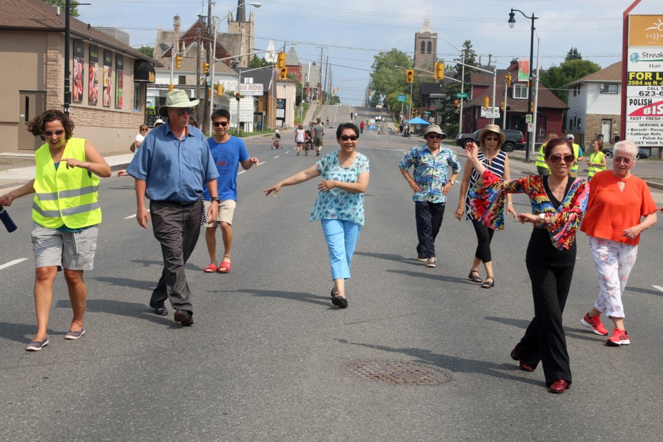 Wendy Huang (centre right) of the Thunder Bay Chinese-Canadian Association quite literally had people dancing in the streets during Open Streets Thunder Bay on Sunday. (Photos by Doug Diaczuk - Tbnewswatch.com). 
