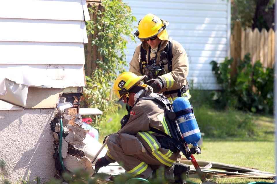 Thunder Bay Fire Rescue crews work to extinguish a fire at a South Rockwood Avenue home after a wasp's nest was lit on fire. 