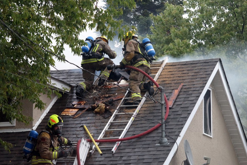 Thunder Bay Fire Rescue crews work to extinguish a fire at a Ryde Avenue home after being ignited by a possible lightning strike. 