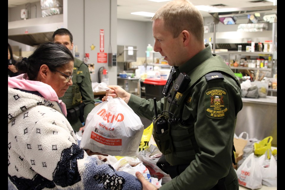 Ministry of Natural Resources and Forestry conservation officer, Davis Viehbeck, hands out moose meat at the RFDA on Wednesday. 