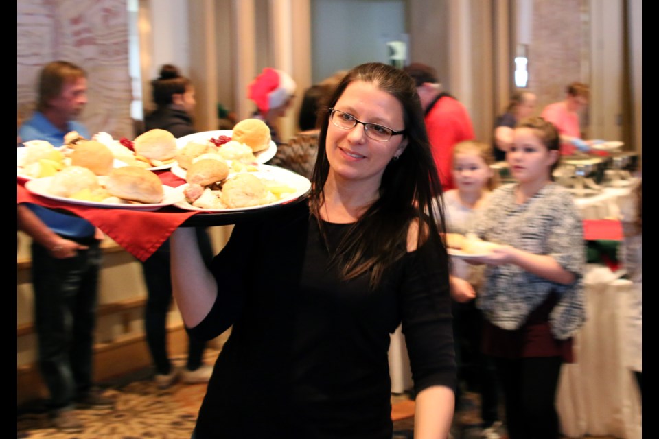 Carolyn Illson, a staff member at the Valhalla Inn, serves some traditional meals during the 24th Annual Community Christmas Dinner hosted by the Salvation Army and the Valhalla Inn. (Photos by Doug Diaczuk - Tbnewswatch.com). 