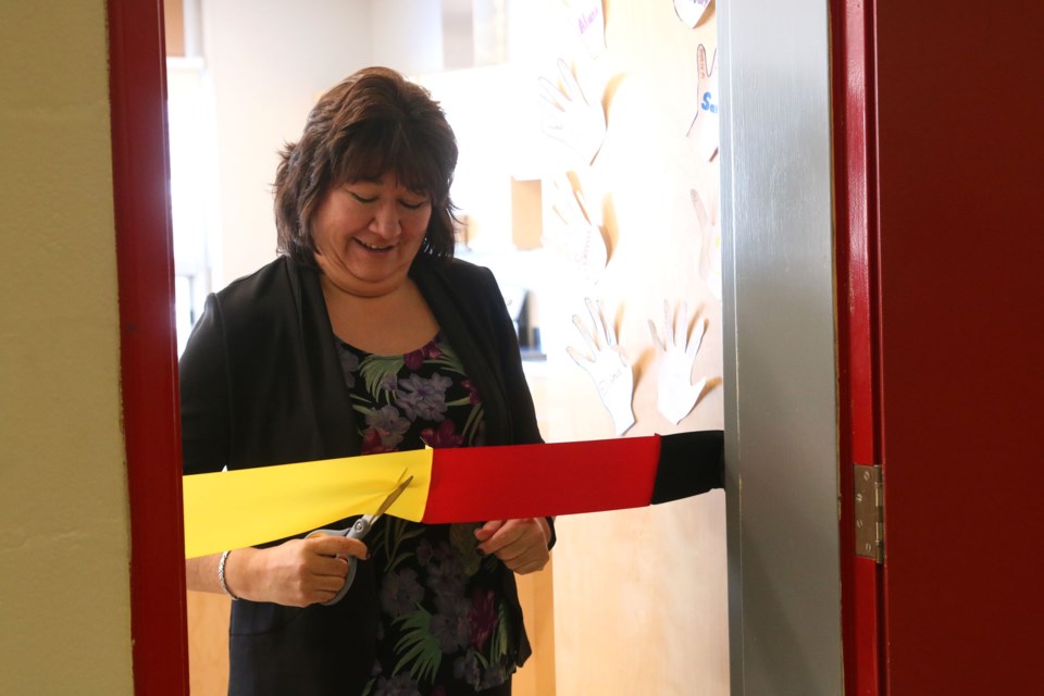 Norma Kejick, Northern Nishnawbe Education Council Executive Director, cuts the ribbon on one of three new classrooms at Dennis Franklin Cromarty High School that are part of the First Nations Trade School. 
