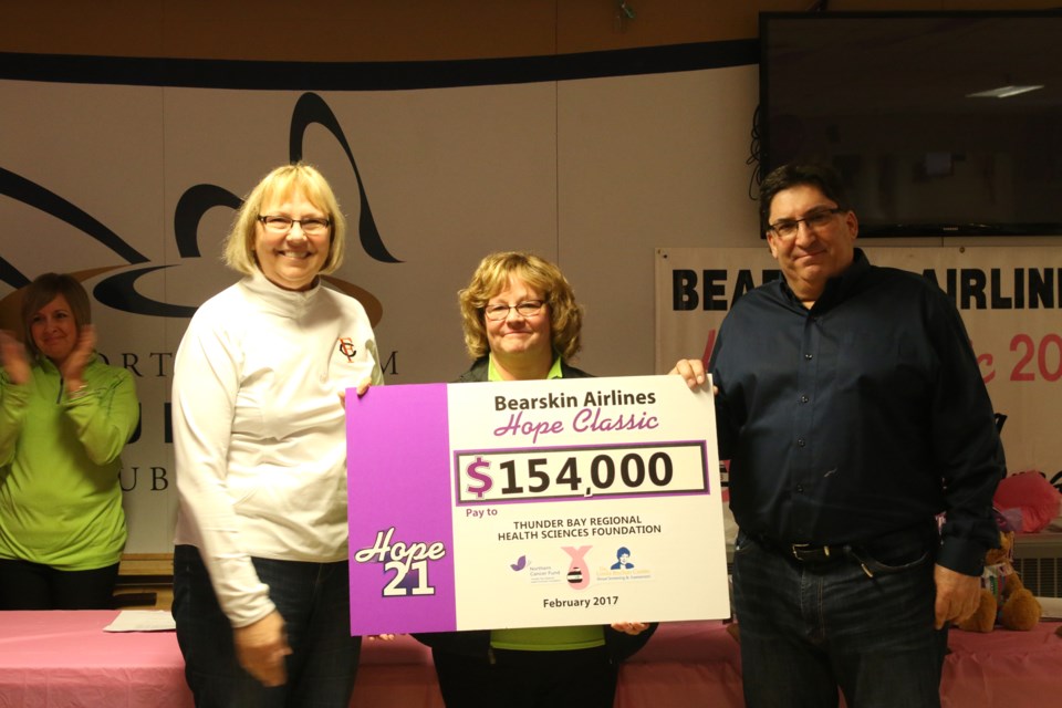 Jody Nesti, chair of the Thunder Bay Regional Health Sciences Foundation board (left), Susan Childs of the Bearskin Airlines Hope Classic (centre), and Ron Hell, director of marketing and Sales with Bearkskin Airlines, announce the total raised during this the 21st Hope Classic, bringing the total raised to more than $3 million. 