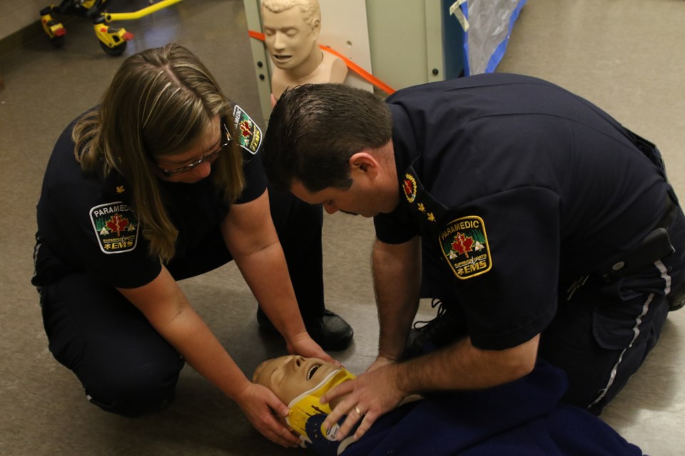 Superior North EMS deputy chief of professional standards Andrew Dillon and superintendent of professional standards Marika Listenmaa demonstrate spinal procedures. Changes to those procedures could result in 60 per cent fewer patients being treated with  