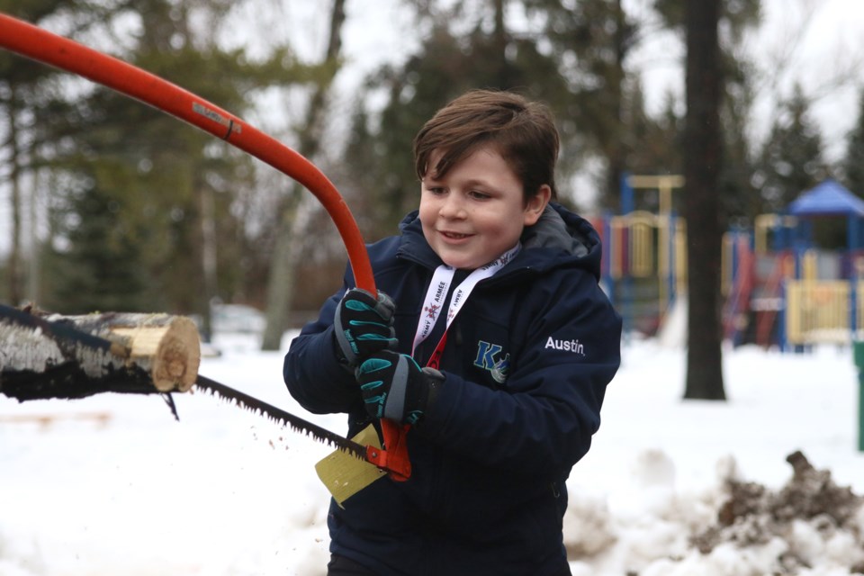 Eight-year-old, Austin McWhirter, tries out the bow saw during the Lumberjack Jamboree at the Vickers Heights Community Centre on Sunday. 