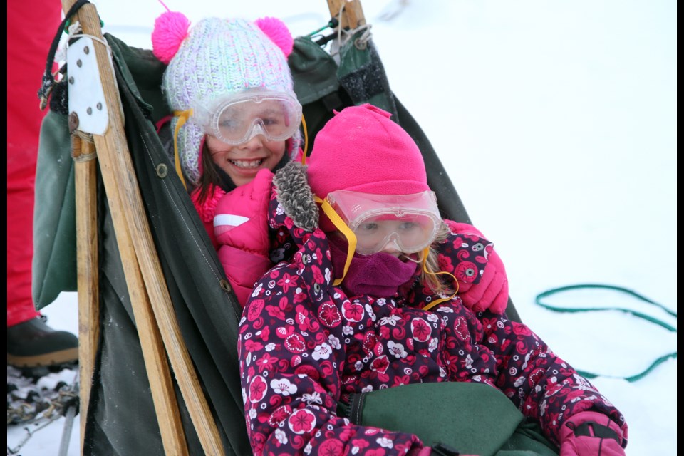 Ameliya Chum (left), Gabrielle Nisbet are taking their first dog sled ride with Boreal Journey's sled dogs.