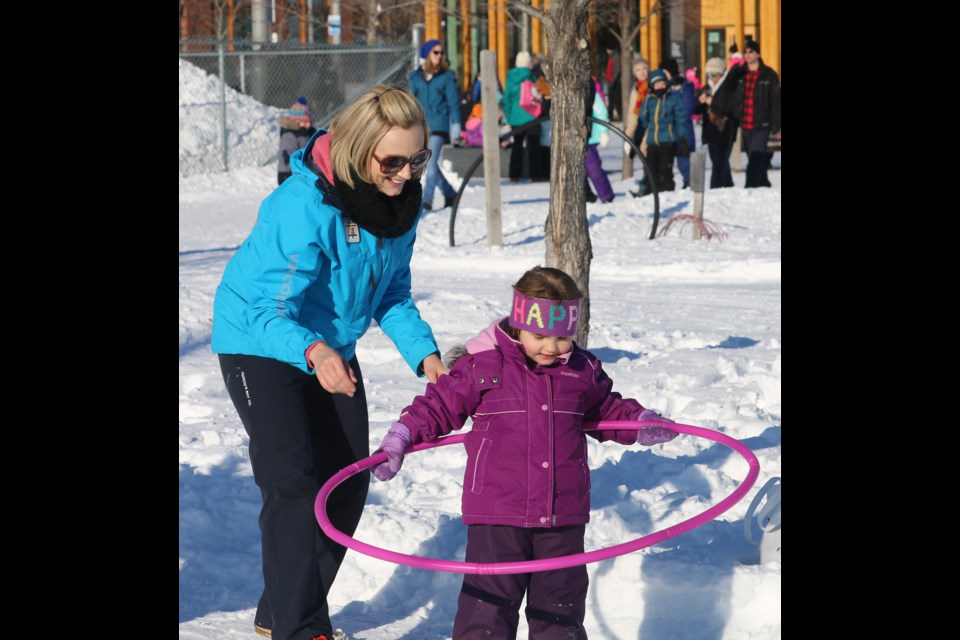 Emily Shandruk and her four-year-old daughter, Audrey, try out some hula-hooping during Winter Fundays at Marina Park on Sunday. 