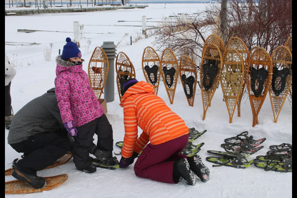 Mila Piksiades gets some help from her dad, Jozef and acting recreation and culture programmer,  Calla Sampson, after trying snowshoeing for the first time during Winter Fundays at Marina Park. 