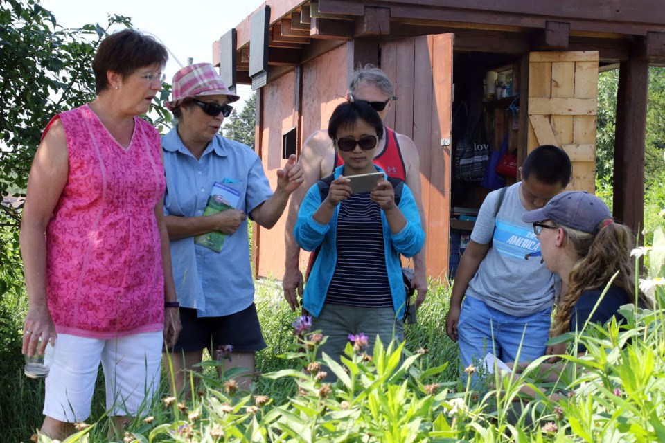 Melissa Davidson giving a guided tour of the Central Natural Environment Gardens. (Michael Charlebois, tbnewswatch.com)