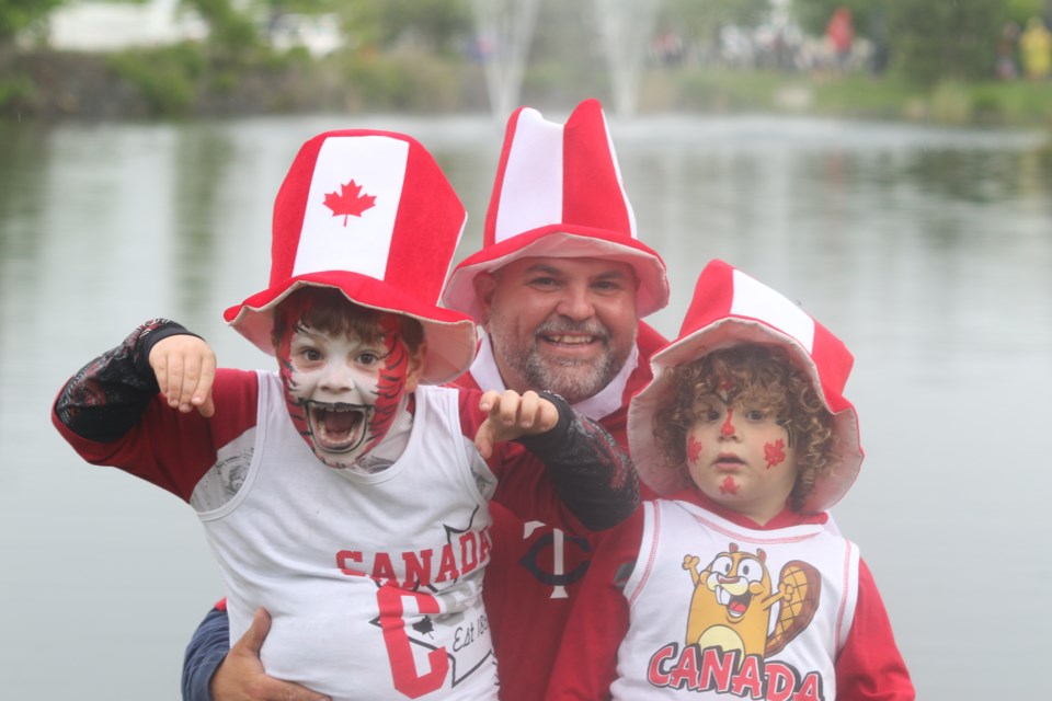 Brody Pykari (left) and his father and sister dazzling the camera with red-and-white colours (Michael Charlebois, tbnewswatch.com)