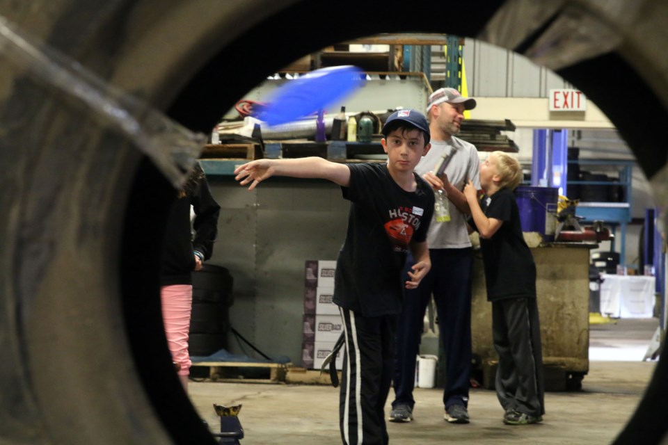 Emmett Cleland takes aim at getting the frisbee through the tires as part of a competition on Sunday to earn the last spot on Team Staal. 