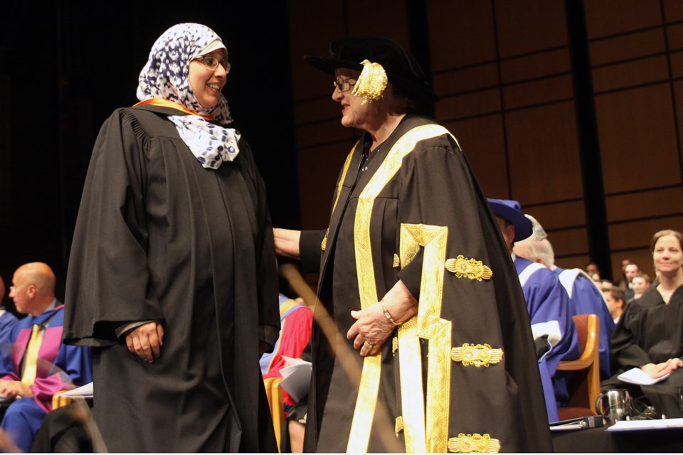 Islam Abu Mahady, a graduate of master of science in engineering, is congratulated by Lakehead University chancellor Lyn McLeod during Friday's convocation ceremony. (Matt Vis, tbnewswatch.com) 