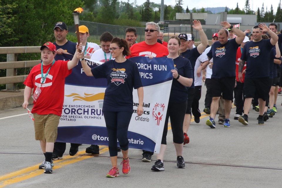 Canadian Special Olympians and law enforcement officials carry the Torch of Hope on Monday, June 19, 2017 at the Pigeon River Border Crossing (Leith Dunick, tbnewswatch.com). 