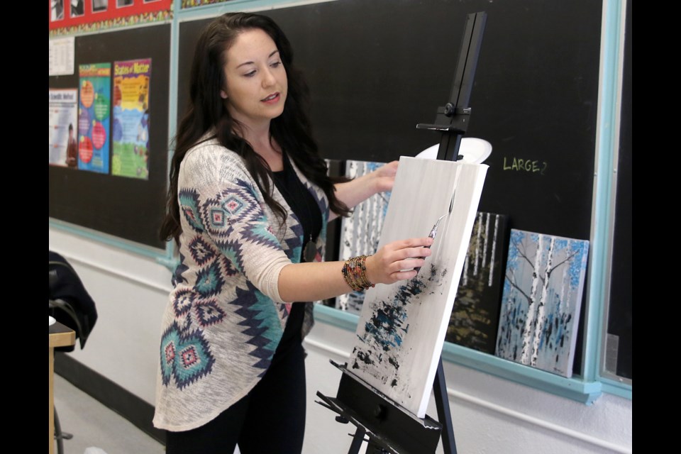 Thunder Bay artist Deena Kruger demonstrates her technique with a pallet knife on Thursday, March 23, 2017 at Kingsway Park Public School (Leith Dunick, tbnewswatch.com). 