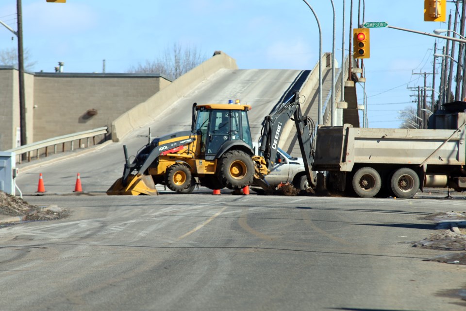 City road crews work to repair a water main break on the corner of Simpson Street and Pacific Avenue, which has closed both streets, including the Pacific Avenue Bridge. 