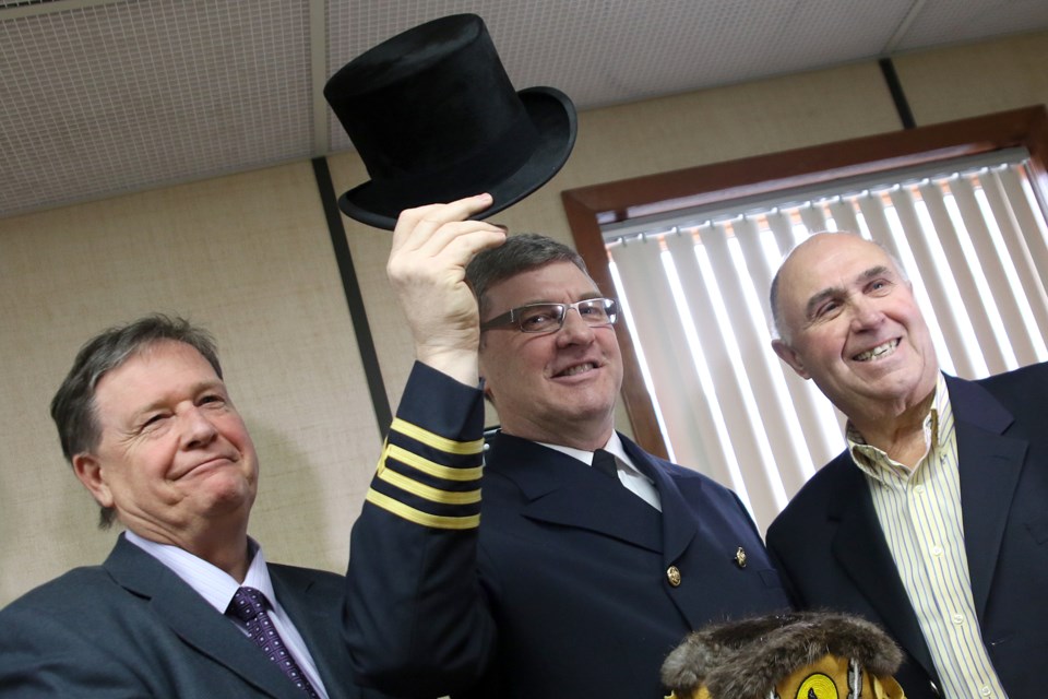 Capt. John Carlson (centre) of the MV Manitoulin on Friday, March 24, 2017, raises a ceremonial top hat for the second time in his shipping career for being at the helm of the first vessel to arrive in Thunder Bay to open the spring shipping season (Leith Dunick, tbnewswatch.com). 
