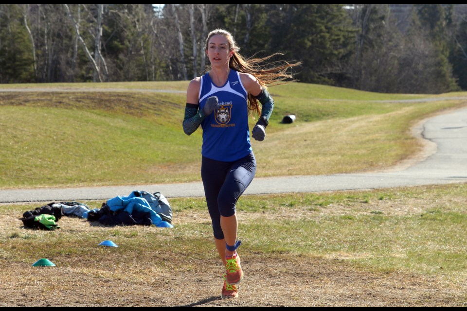 Kayla Gallo about to cross the finish line at the inaugural 10k Road Race, finishing first for the women with a time of 40:48. 