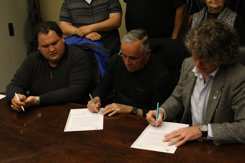 Mathew Dupuis (left), Edward Wawia, and Richard Harvey sign Memorandum of Understanding. (Michael Charlebois, tbnewswatch.com)