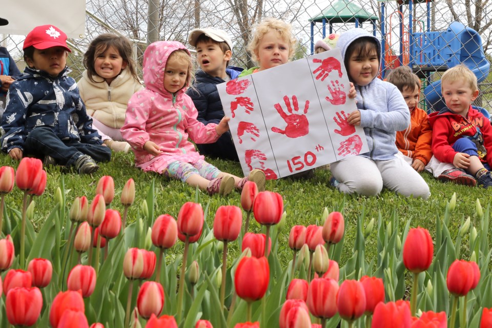 Children from the Grace Remus Day Care celebrate the blooms comng out at the Pioneer Ridge tulip garden on Wednesday, May 31, 2017 (Leith Dunick, tbnewswatch.com). 