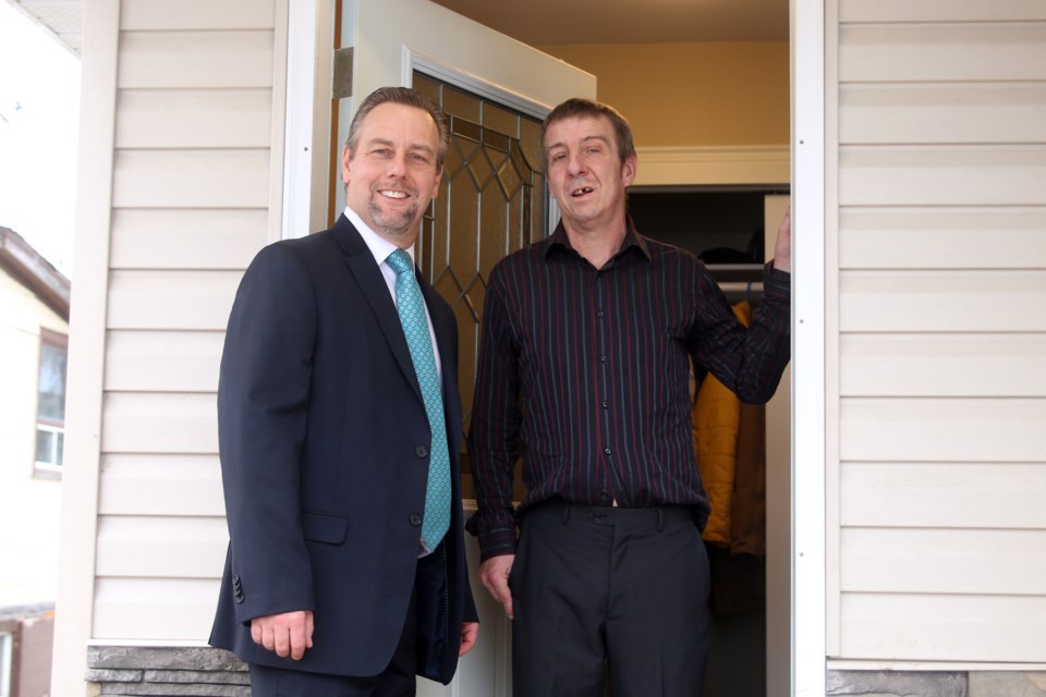 Dan Stezenko, CEO for Habitat for Humanity Thunder Bay, celebrates the completion of the latest Habitat build with new homeowner, Ron Sawchuk. 