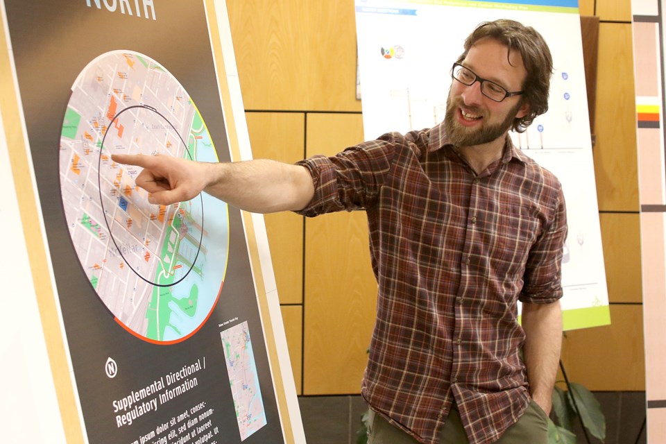 City mobility co-ordinator Adam Krupper shows off possible signage beind considered for Thunder Bay's wayfinding program. (Leith Dunick, tbnewswatch.com). 