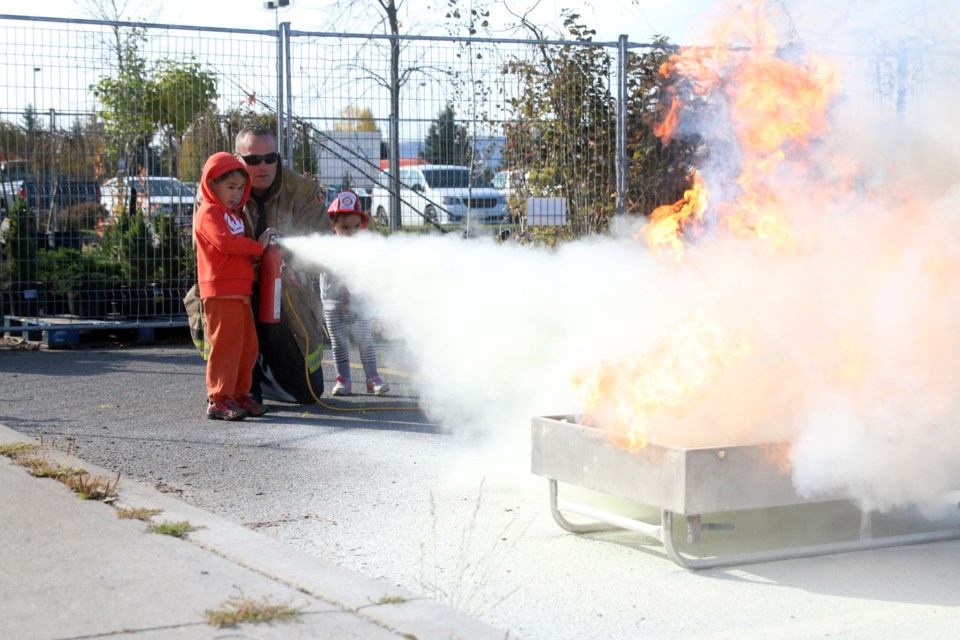 CJ Dorota, 4, and Jamie Dorota, 2, get a lesson in how to use a fire extinguisher from Kevin Anderson, fire prevention officer with Thunder Bay Fire Rescue. (Photos by Doug Diaczuk - Tbnewswatch.com). 