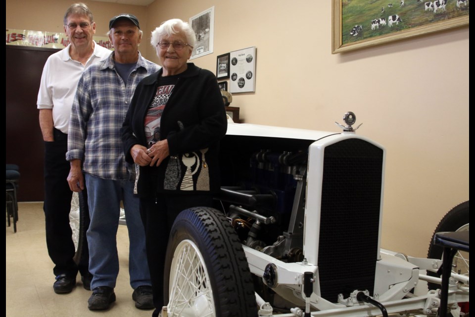 Dave Cano, Russ Wanzuk, and Duke Hunt Museum curator, Lois Garrity stand in front of the King's Special during the Thunder Bay Racing Reunion. 