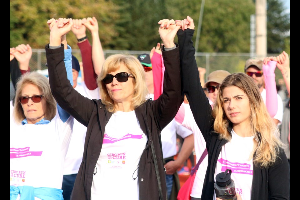 Runners join fingers, pledging to fight to end breast cancer during the 21st Annual CIBC Run for the Cure on Sunday. (Photos by Doug Diaczuk - Tbnewswatch.com). 