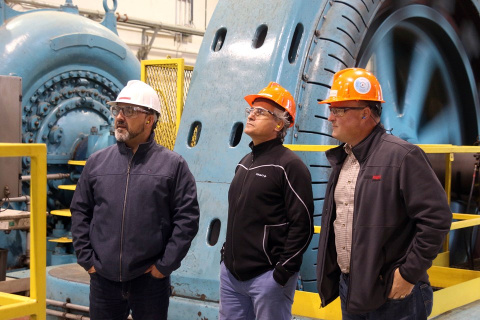 Glenn Thibeault, Ontario Minister of Energy and Member of Parliament for Sudbury, Minister Bill Mauro, and Paul Giardetti, vice president of Regional Operation with Ontario Power Generation, tour the Kakabeka Generating Station. 