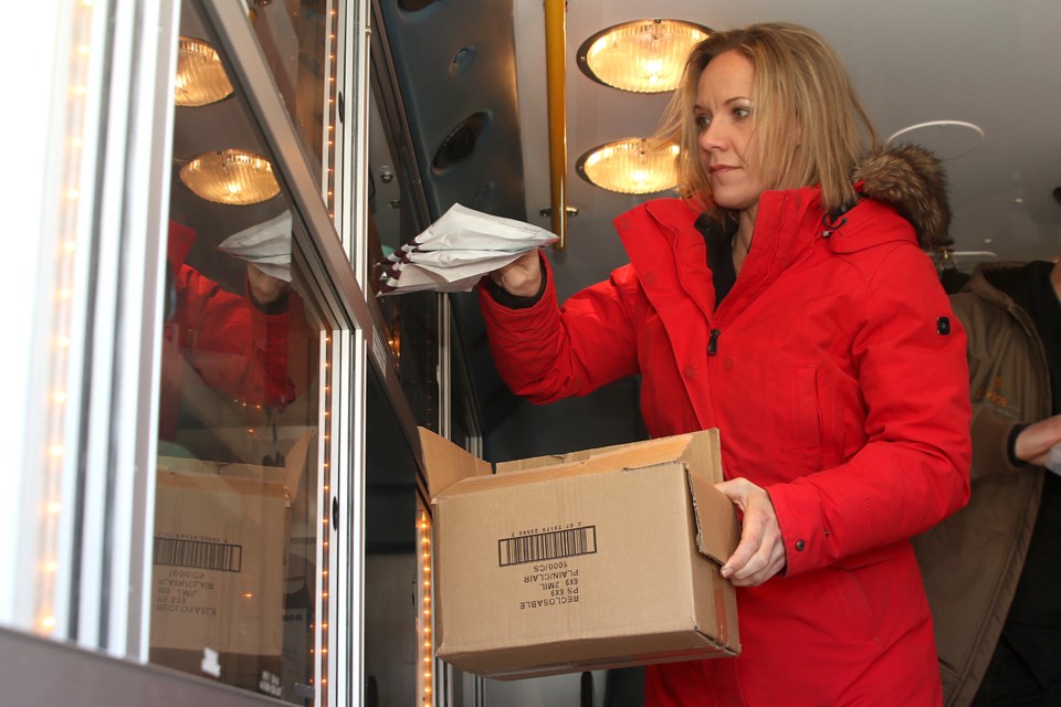 Registered nurse Jessica Laesser puts away supplies in Ellie, a retrofitted ambulance being used for a joint street outreach program offered by the Joseph Esquega Health Centre and Elevate NWO. (Leith Dunick, tbenewswatch.com)