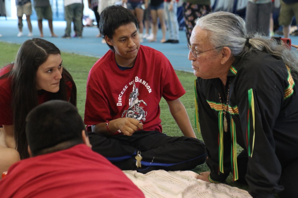 Elder Jerry Martin (right) passes wisdom on to members of the Diocese of Brandon. (Michael Charlebois, tbnewswatch)