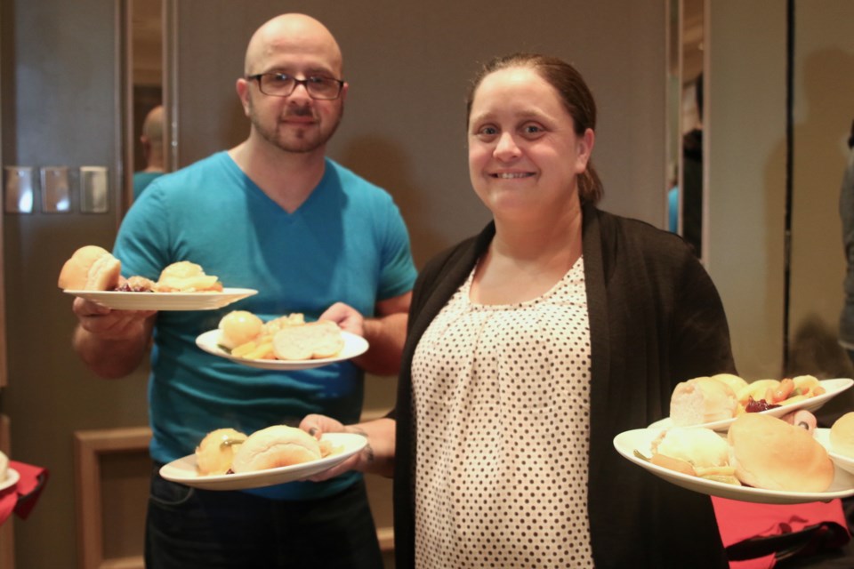 Volunteers Emanuel Sposato (left) and Kristin Tsubouchi were busy serving up a holiday meal during the Salvation Army and Valhalla Inn Christmas Dinner on Sunday. (Photos by Doug Diaczuk - Tbnewswatch.com). 