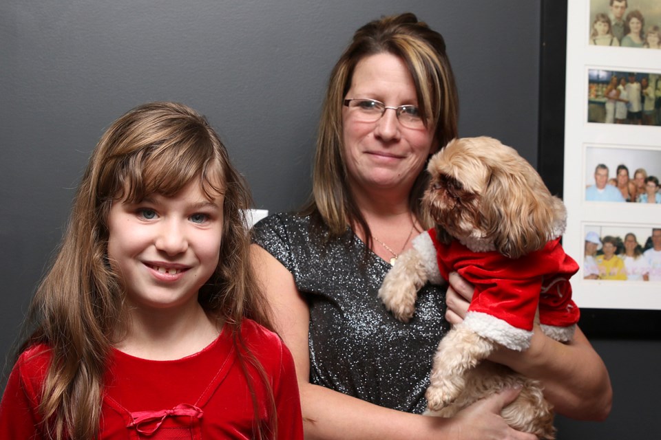 Donnalynn Laughton, 9, and her mother Shelley and dog Honey celebrate their new McPherson Street home on Friday, Dec. 7, 2018. The home was built by Habitat for Humanity Thunder Bay. (Leith Dunick, tbnewswatch.com)