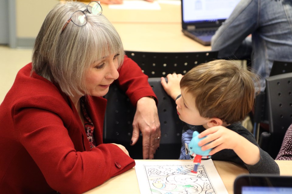 MP Patty Hajdu and Aiden Prairie discussing Fruit Loops at the Thunder Bay Counselling Centre. (Michael Charlebois / tbnewswatch)