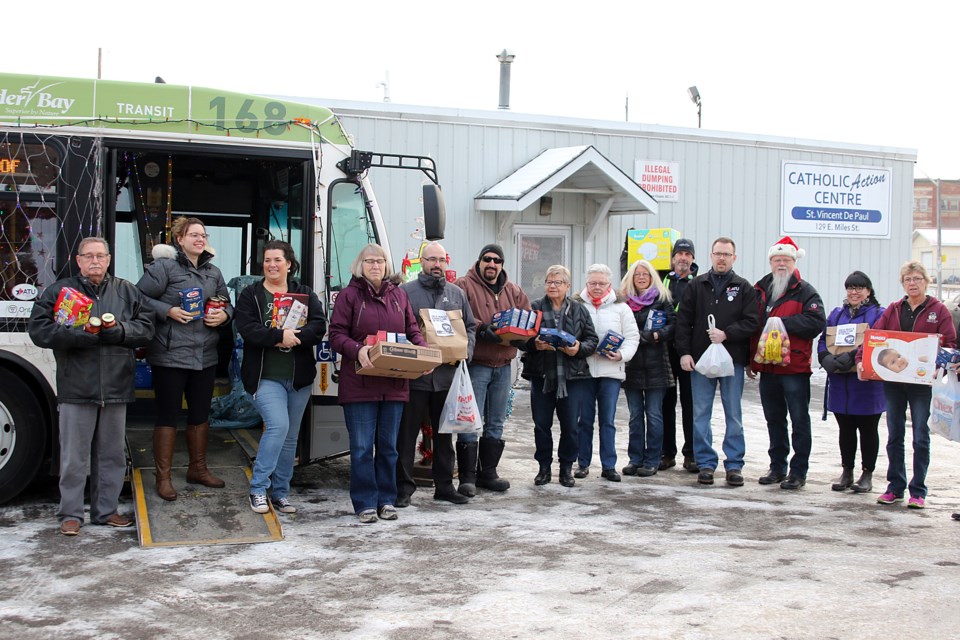 Volunteers help unload the Santa Bus at the Thunder Bay Food Bank on Monday, Dec. 10, 2018. (Leith Dunick, tbnewswatch.com)