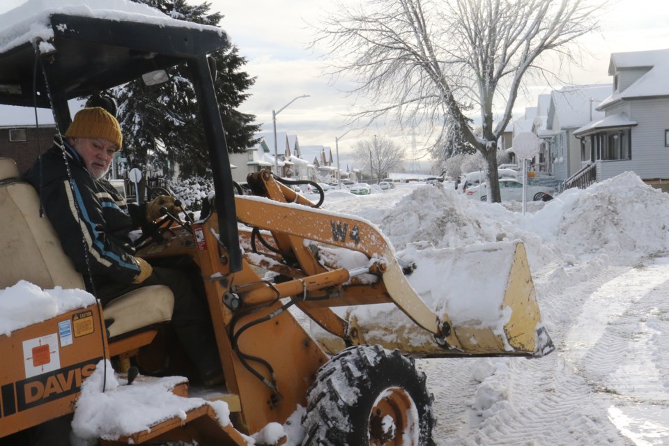 A McPherson Street resident plows the road on Friday. (Michael Charlebois, tbnewswatch)