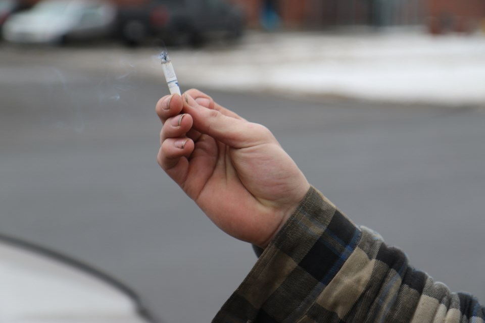 A student at Westgate Collegiate Vocational Institute holds a cigarette outside of the school. Students are now required to smoke 20 metres from school property under the The Smoke-Free Ontario Act. (Michael Charlebois, tbnewswatch)