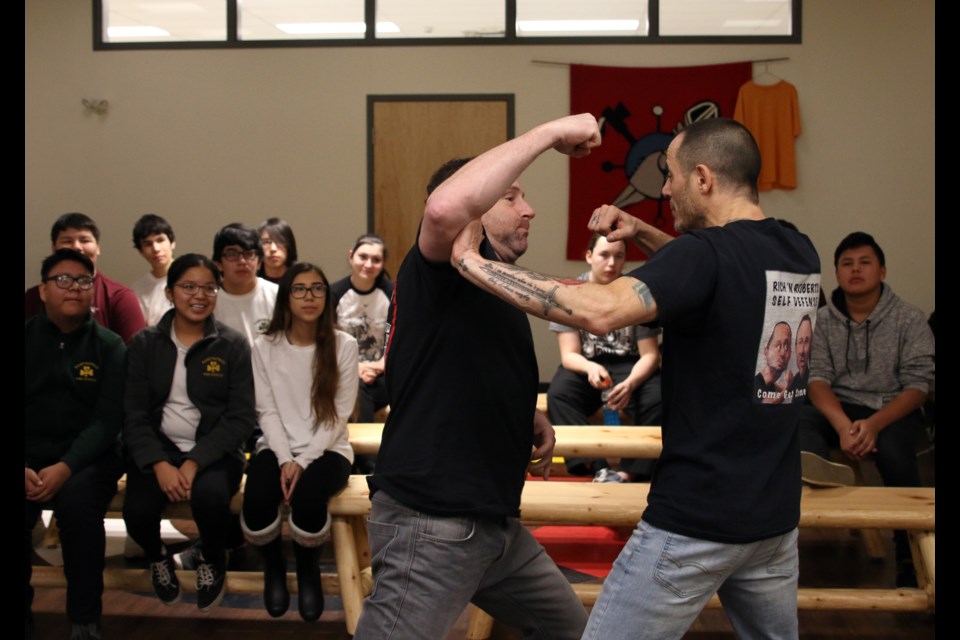 Safe International instructors, Chris Roberts (left) and Richard Dimitri (right), demonstrate to students at St. Patrick's High School some of the basics of self-defense during a training course on Wednesday. 