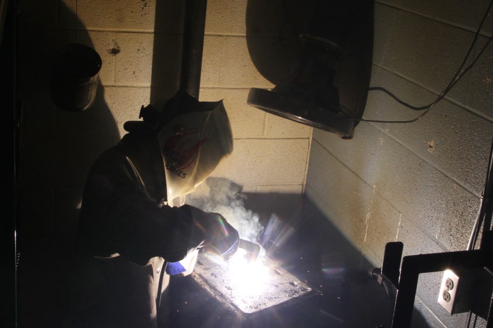 Sparks sly as a student welds a piece of metal at Superior Collegiate Vocational Institute. (Michael Charlebois, tbnewswatch)
