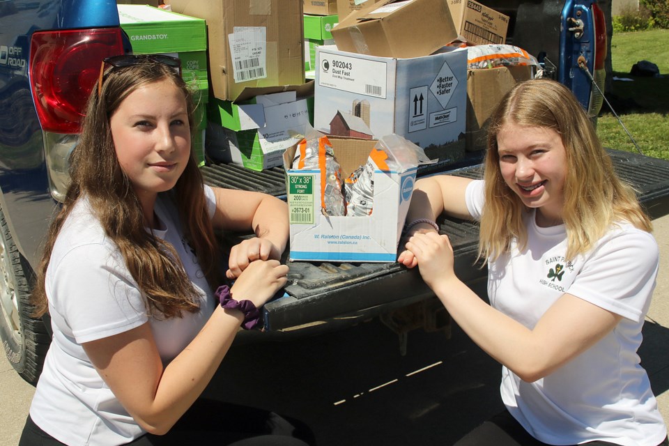 Fourteen-year-olds Cassie MacDonald (left) and Piper Plavins, Grade 9 students at St. Patrick High School, helped collect 655 kilograms of used batteries to divert from the local landfill. (Leith Dunick, tbnewswatch.com)