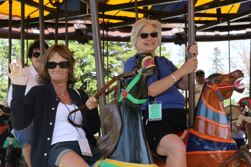 Members of the Thunder Bay Vintage Sports Car Club take a ride  on some of the new additions to the carousel. (Michael Charlebois, tbnewswatch)