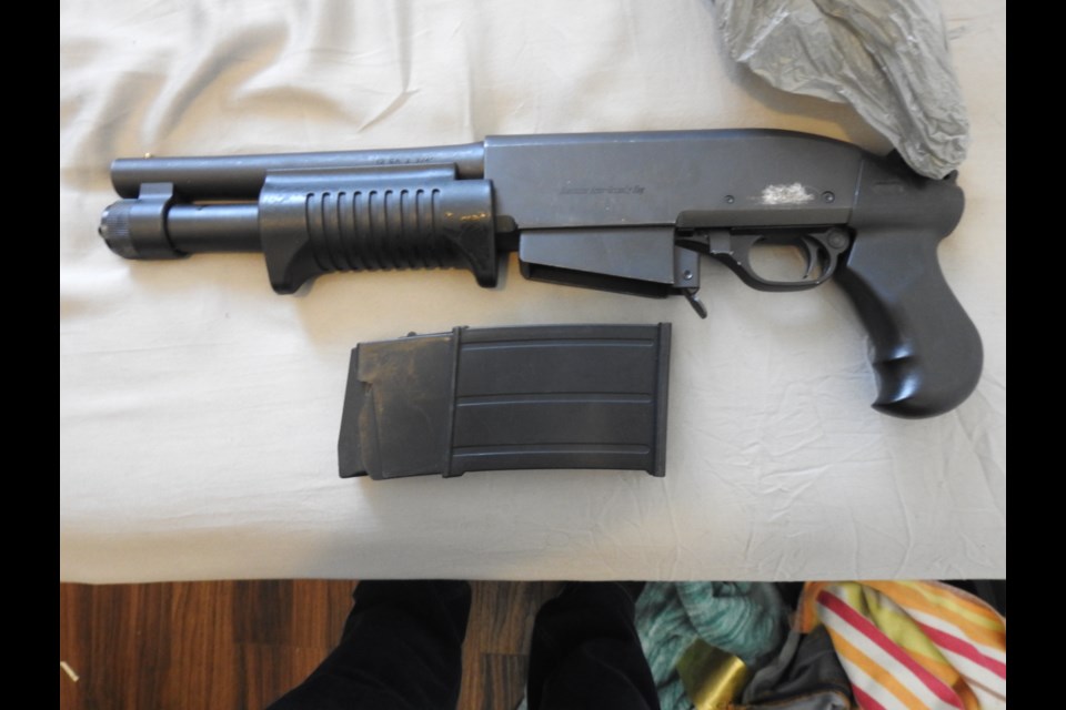         A shotgun and ammunition seized by police during a raid at a South Cumberland Street multi-residential unit on Thursday, March 29, 2018. (Submitted by Thunder Bay Police Service)