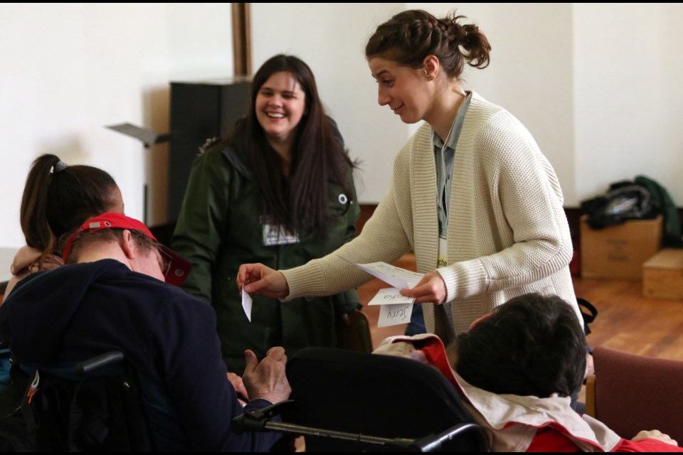 Rachel Brown, a volunteer with Urban Abbey, greets guests during the city's first Dementia Cafe at the Urban Abbey. 