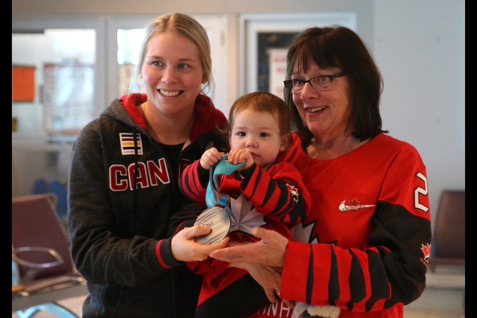 Haley Irwin (left) shares her Olympic silver medal with her mother, Kerry Irwin, and niece, Lillia. 