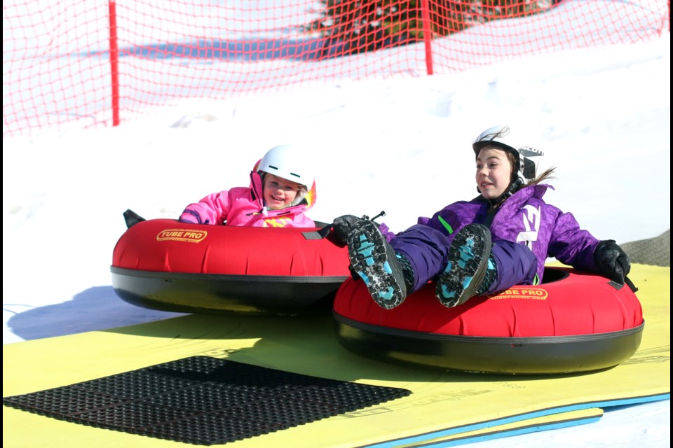 Layla Weiers (right) and her sister Hannah glide down the tubing run at Mount Baldy Ski Area during a March break getaway. 