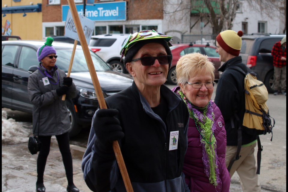 Veijo Maki and Kaija Maki march in the parade. Veijo has a button on his hat for nearly every parade his has marched in, which is almost 30. 
